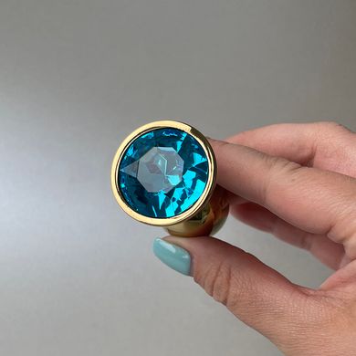 Золотая анальная пробка с голубым кристаллом (2,8 см) - фото